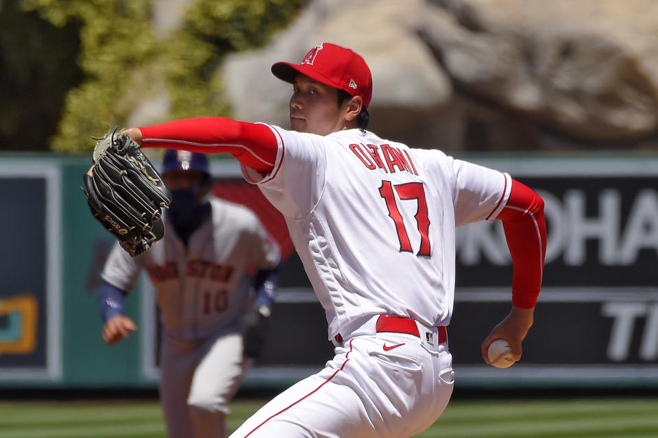 Los Angeles Angels pitcher Shohei Ohtani, right, of Japan, winds up as Houston Astros' Yuli Gurriel stands at second during the second inning of a baseball game Sunday, Aug. 2, 2020, in Anaheim, Calif. (AP Photo/Mark J. Terrill)