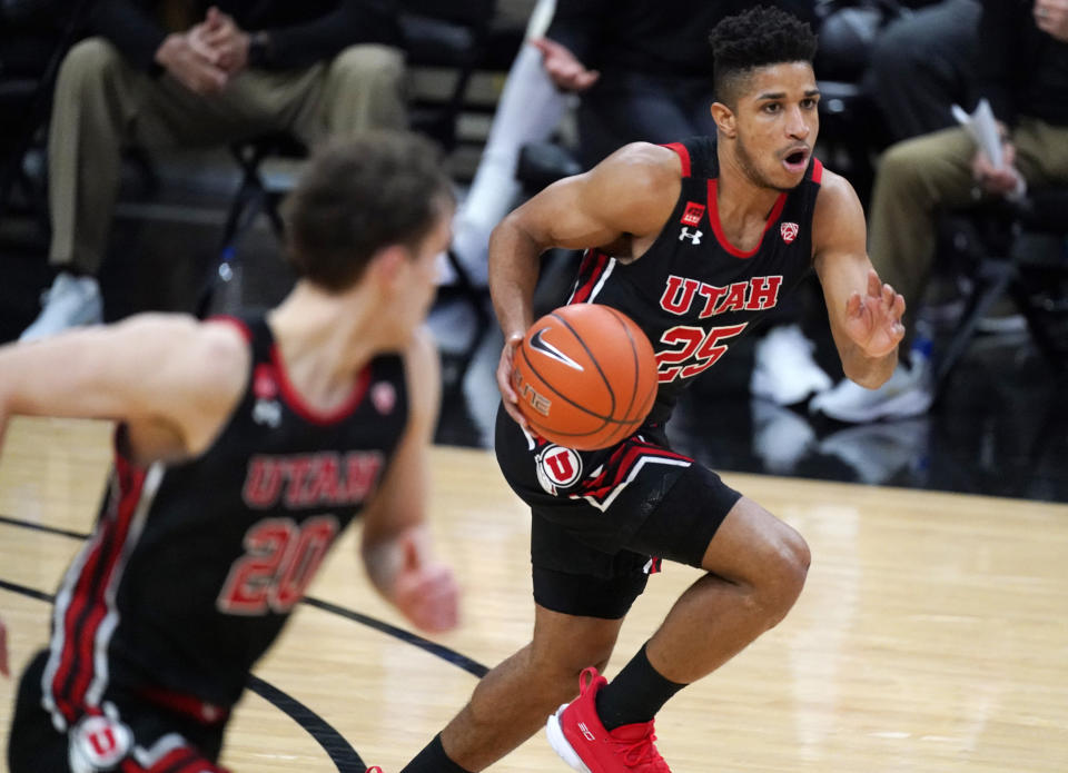 Utah guard Alfonso Plummer (25) brings the ball upcourt while flanked by forward Mikael Jantunen in the second half of an NCAA college basketball game against Colorado, Saturday, Jan. 30, 2021, in Boulder, Colo. (AP Photo/David Zalubowski)