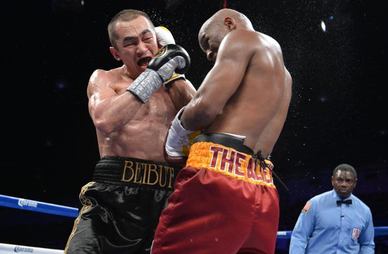 Bernard Hopkins (R) of the US lands a right on Beibut Shumenov of the US during their WBA & IBA Light-heavyweight title fight at the DC Armory in Washington on April 19, 2014