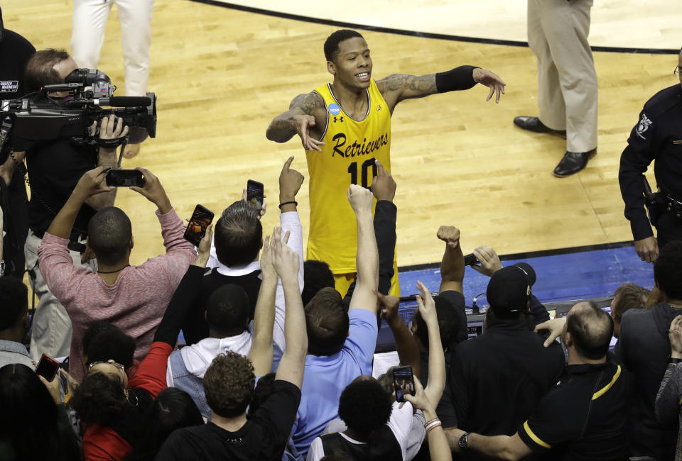 UMBC’s Jairus Lyles (10) celebrates with fans after the team’s 74-54 win over Virginia. (AP)