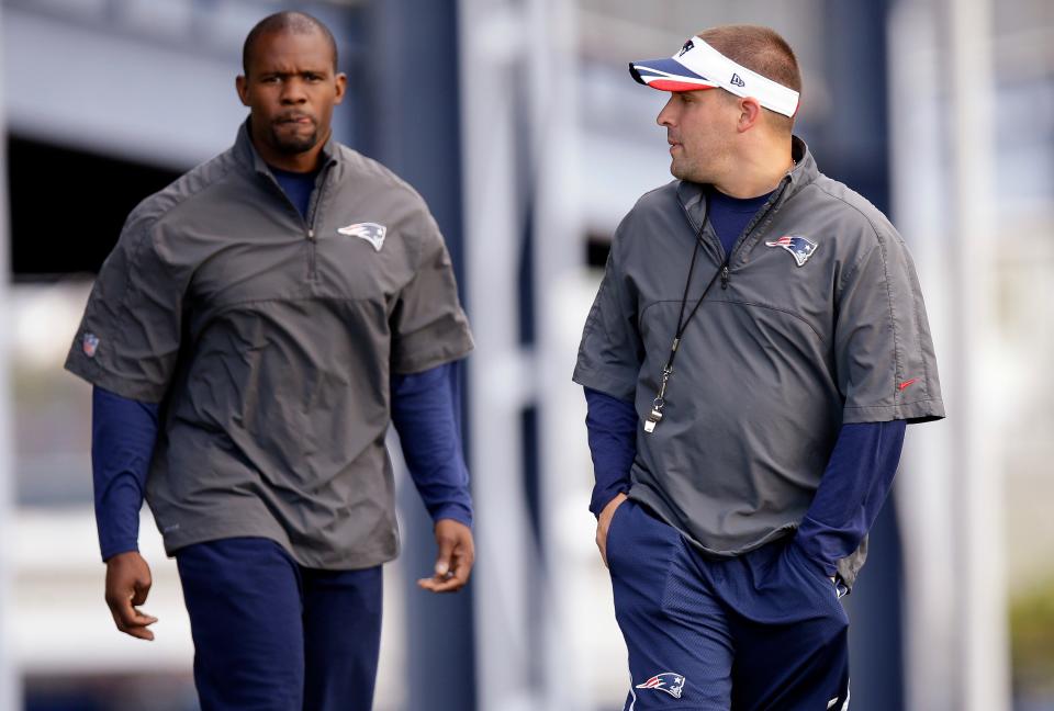 New England Patriots offensive coordinator Josh McDaniels, right, talks with safety's coach Brian Flores as they walk out to the field before practice, Oct. 8, 2014, in Foxborough, Mass. AP Photo/Stephan Savoia, File)