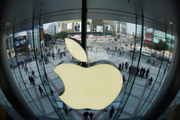 Chinese customers enter the newly opened Apple Store in Wangfujing shopping district on October 20, 2012 in Beijing, China. Apple Inc. opened its sixth retail store on the Chinese mainland Saturday. The new Wangfujing store is Apple's largest retail store in Asia. (Photo by Feng Li/Getty Images)