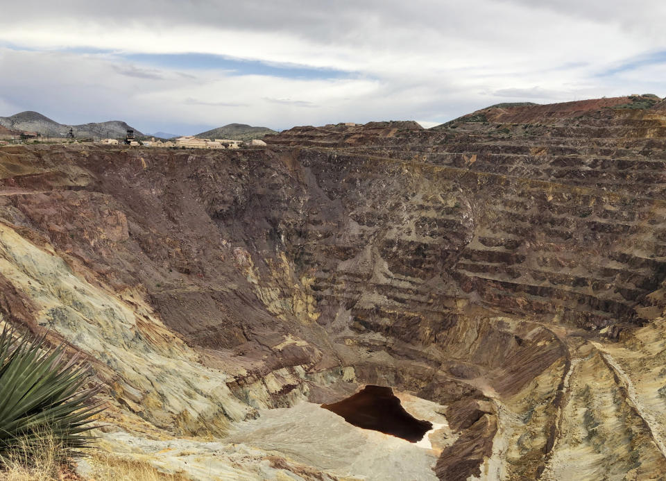 FILE - This May 12, 2019 file shows what's left of the Lavender pit mine outside the southeastern Arizona city of Bisbee, where the copper operation stopped in 1974.The mine and the town are the subject of "Bisbee '17," a story of how some 1,200 miners, most of them immigrants, were pulled violently from their homes in Bisbee by a private police force and put on cattle cars for deportation to a desolate area of New Mexico in 1917. The dark history of Bisbee was largely an open secret for decades in the funky old copper town just seven miles north of the U.S.-Mexico border. It's the sixth film of director Robert Greene, who said he learned about the town southeastern Arizona around 15 years ago. (AP Photo/Anita Snow)