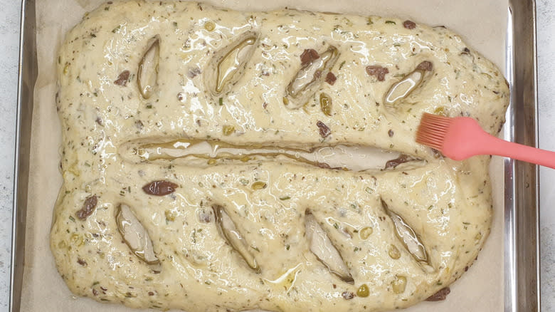 Brushing the fougasse with oil