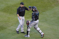 Miami Marlins relief pitcher Brandon Kintzler, left, and catcher Chad Wallach (17) celebrate a 2-0 victory over the Chicago Cubs in Game 2 of a National League wild-card baseball series Friday, Oct. 2, 2020, in Chicago. The Marlins won the series 2-0 to advance to the division series. (AP Photo/Nam Y. Huh)