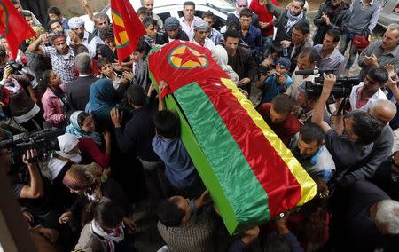 The coffin of one of the four Kurdish woman fighters killed during clashes against Islamic State fighters in Kobani is carried to the cemetery in the southeastern town of Suruc, Sanliurfa province, October 14, 2014. REUTERS/Umit Bektas