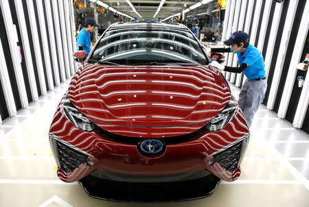 Employees of Toyota Motor Corp. work on the assembly line of Mirai fuel cell vehicle (FCV) at the company's Motomachi plant in Toyota, Aichi prefecture, Japan, May 17, 2018. REUTERS/Issei Kato