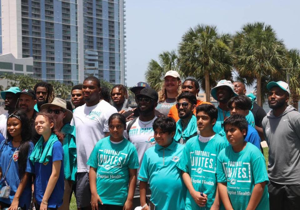 The Miami Dolphins rookie class poses for a photo with Miami PAL, Miami Police Athletic League, left, and the Islamic Center of Greater Miami, right, during a historic walking tour of Downtown Miami with local community groups on Wednesday, June 15, 2022 beginning with tour leaders at the History Miami Museum.