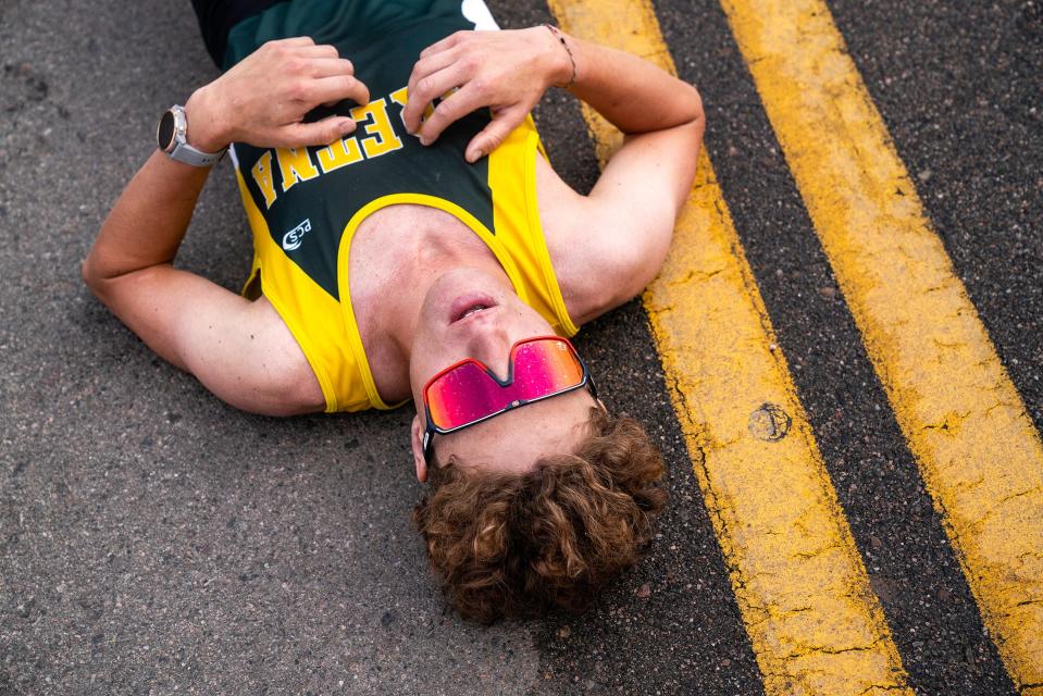 Benjamin Randall lays on the ground after finishing the Colorado Marathon on May 7, 2023. Randall finished in first place with a record time of 2:24:06.