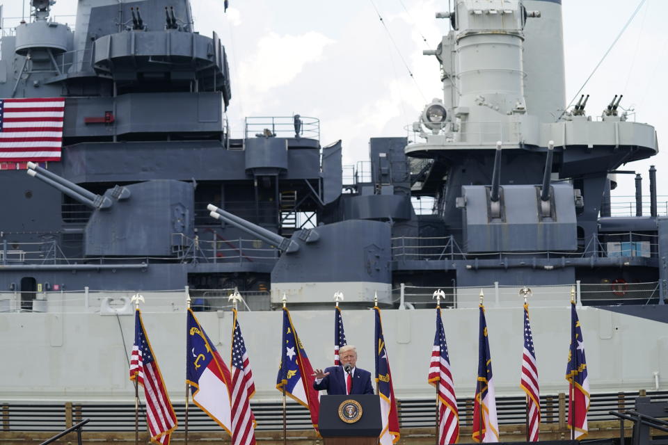 With the USS Battleship North Carolina in the background, President Donald Trump speaks during an event to designate Wilmington as the first American World War II Heritage City, Wednesday, Sept. 2, 2020, in Wilmington, N.C. (AP Photo/Evan Vucci)