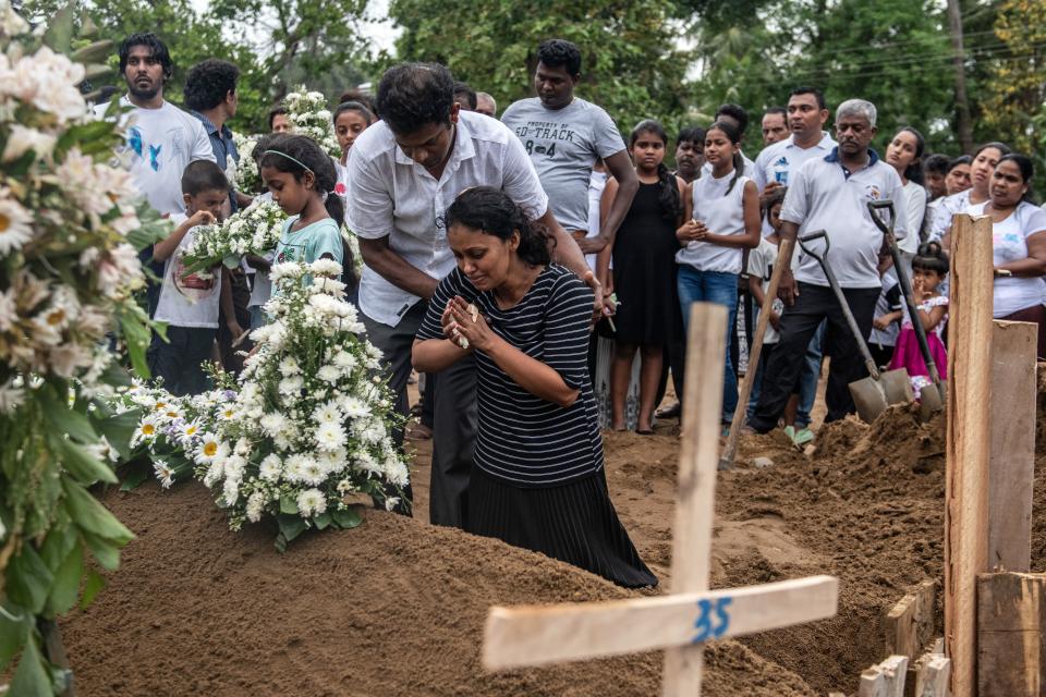 A woman grieves at the grave after a funeral for a person killed in the Easter Sunday attack on St Sebastian's Church, on April 25, 2019 in Negombo, Sri Lanka. At least 359 people were killed and 500 people injured after coordinated attacks on churches and hotels on Easter Sunday which rocked three churches and three luxury hotels in and around Colombo as well as at Batticaloa in Sri Lanka.