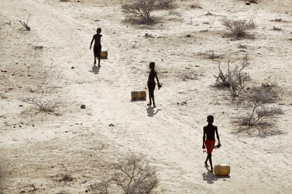FILE - Young boys pull containers of water as they return to their huts from a well in the village of Ntabasi amid a drought in Samburu East, Kenya, Oct, 14, 2022. Tropical Cyclone Freddy, which has already caused 21 deaths and displaced thousands of others in Madagascar and Mozambique, is set to make landfall in Mozambique again, Friday, March 10, 2023. Meteorologists told The Associated Press the uneven and devastating water distribution across Africa’s eastern states is caused by natural weather systems and exacerbated by human-made climate change with cyclones sucking up water that would otherwise be destined for nations further north. (AP Photo/Brian Inganga, File)