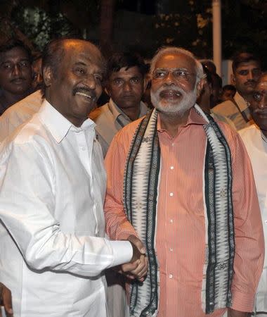 FILE PHOTO: Narendra Modi shakes hand with film star Rajinikanth (L) before addressing an election campaign rally in Chennai April 13, 2014. REUTERS/Babu/File Photo