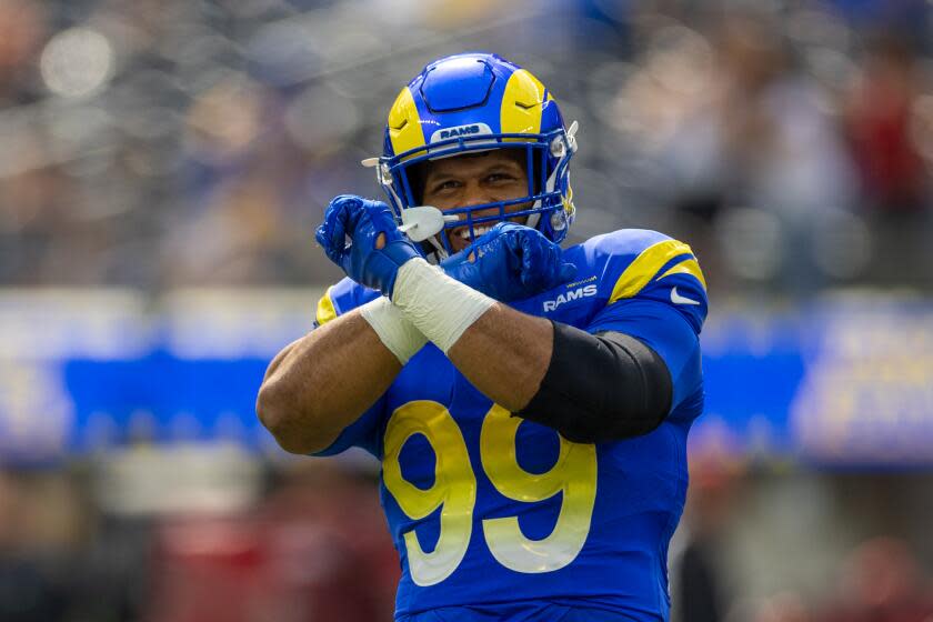 Rams defensive tackle Aaron Donald (99) gestures to fans.