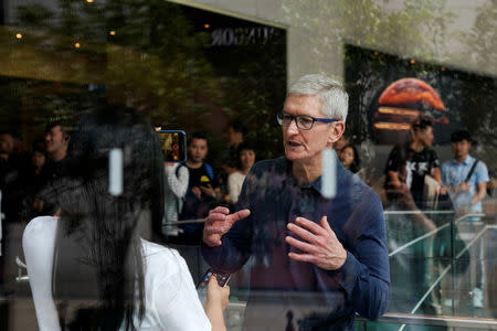 FILE PHOTO: Apple CEO Tim Cook visits an Apple store in Shanghai, China October 9, 2018. REUTERS/Aly Song/File Photo