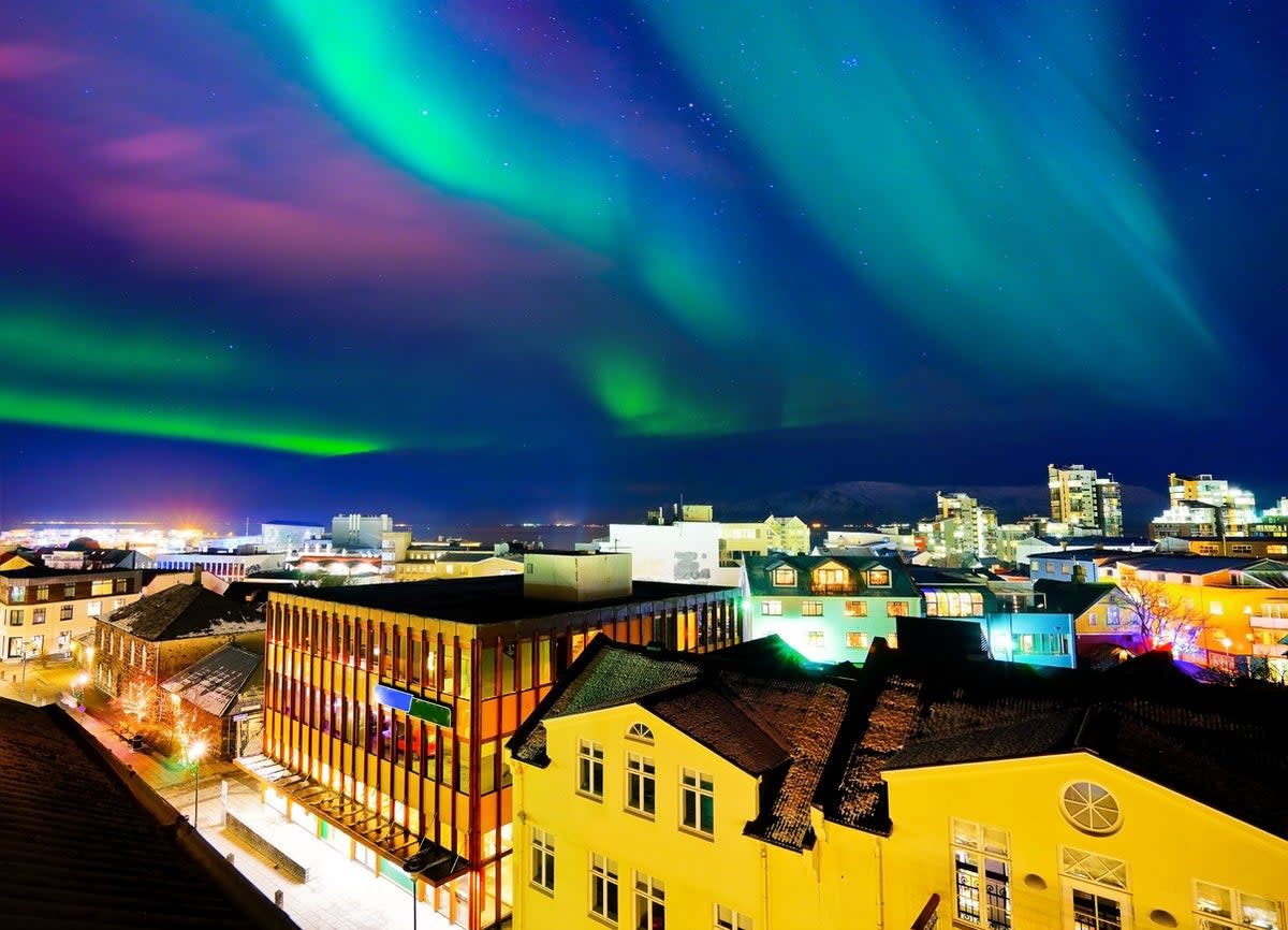 Whisps of purple and green illuminate central Reykjavik (Getty Images/iStockphoto)