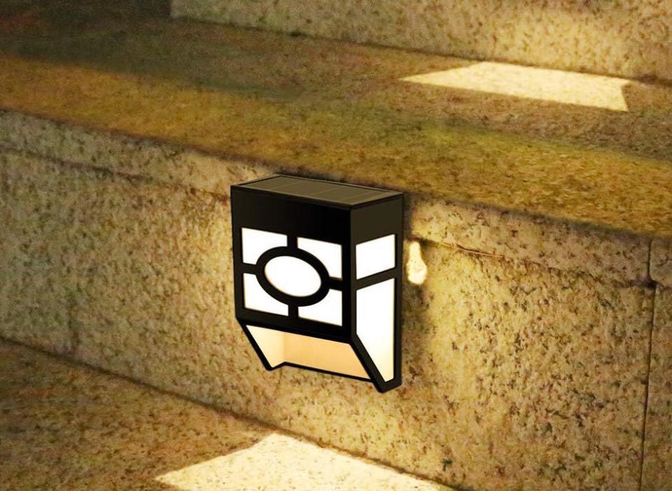 Close up of a stylish wall lamp on a porch staircase