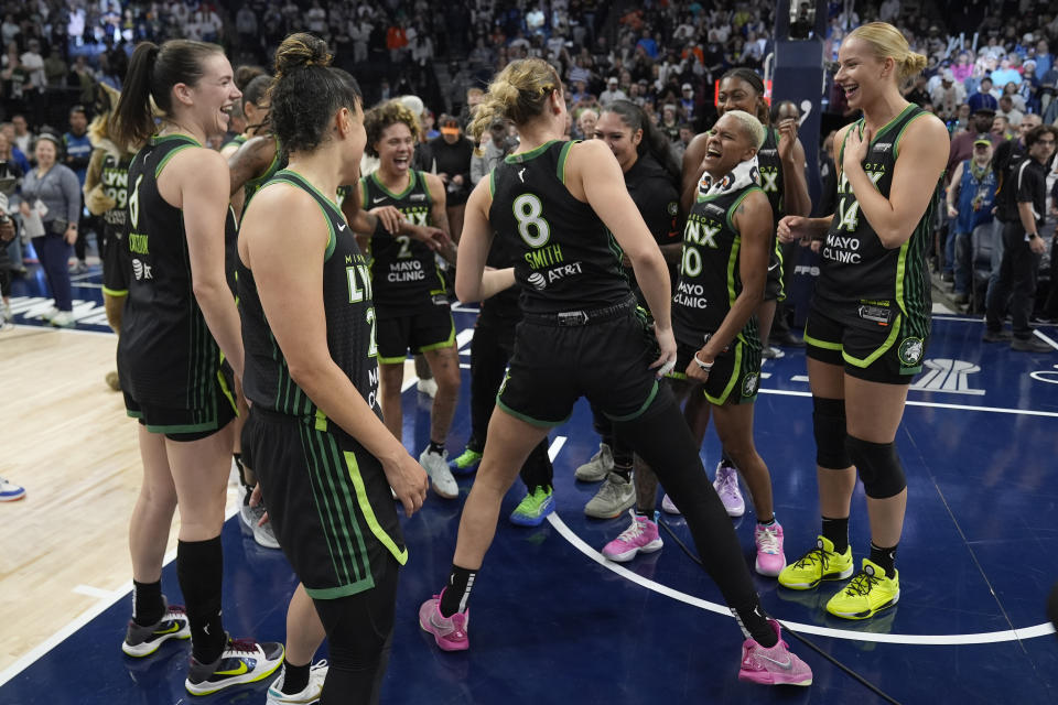 Minnesota Lynx players celebrates after the 88-77 win against the Connecticut Sun of Game 5 of a WNBA basketball semifinals, Tuesday, Oct. 8, 2024, in Minneapolis. (AP Photo/Abbie Parr)