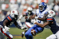 Kentucky quarterback Terry Wilson (3) fumbles the ball as he is tackled by Auburn defensive back Jamien Sherwood (20) and defensive end T.D. Moultry (99) during the fourth quarter of an NCAA college football game on Saturday, Sept. 26, 2020, in Auburn, Alabama. (AP Photo/Butch Dill)