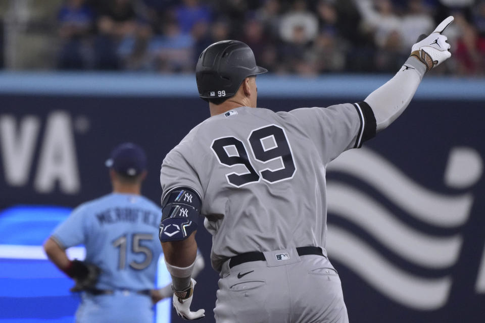 New York Yankees' Aaron Judge (99) gestures toward the team's bullpen as he runs the bases after hitting a two-run home run against the Toronto Blue Jays during the eighth inning of a baseball game Tuesday, May 16, 2023, in Toronto. (Chris Young/The Canadian Press via AP)