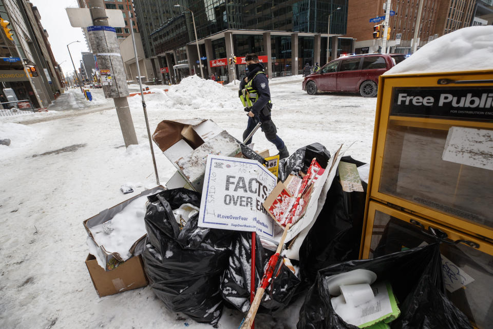 Placards and garbage are seen in downtown Ottawa on Sunday, Feb. 20, 2022, after police worked to clear a trucker protest that was aimed at COVID-19 measures that grew into a broader anti-government protest. (Cole Burston/The Canadian Press via AP)