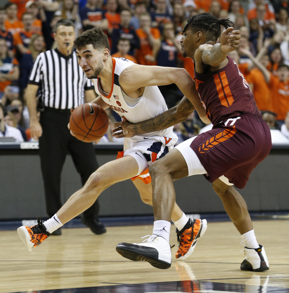 Virginia guard Ty Jerome (11) drives past Virginia Tech guard Ahmed Hill, right, during the first half of an NCAA college basketball game in Charlottesville, Va., Tuesday, Jan. 15, 2019. (AP Photo/Steve Helber)