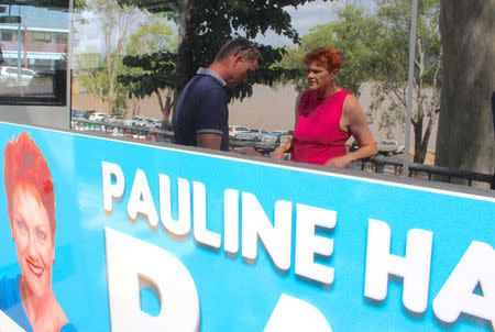 Australian senator Pauline Hanson talks with one of her staff as she stands next to her bus displaying an election poster in the northern Australian town of Rockhampton in Queensland, Australia, November 8, 2017. Picture taken November 8, 2017. REUTERS/Jonathan Barrett