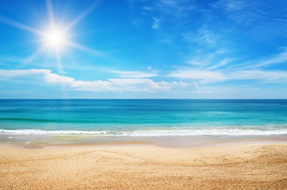 A beach under a sunny sky.