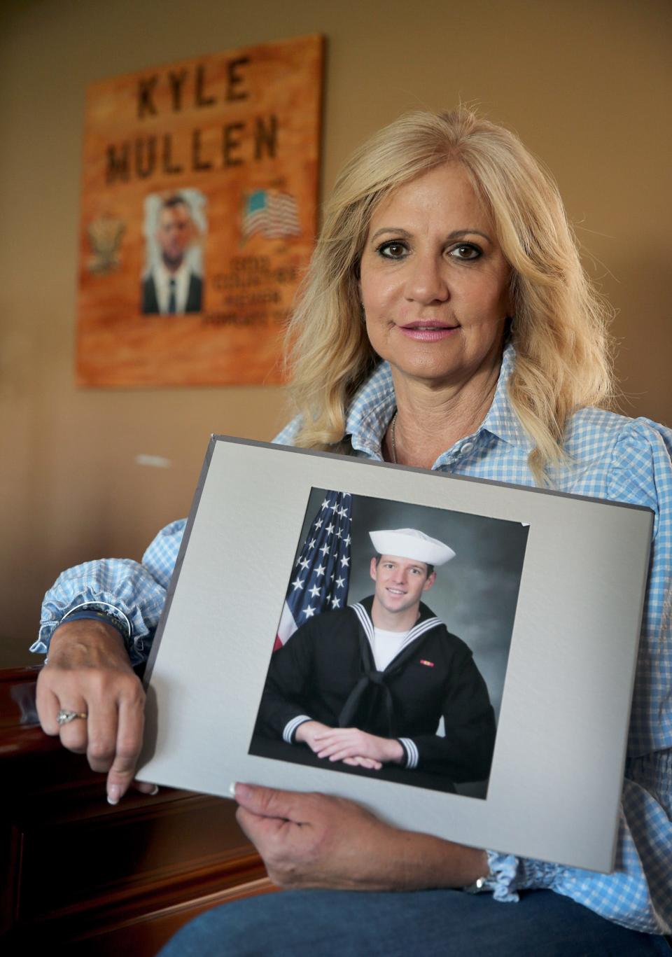 Regina Mullen holds a photo of her son Kyle in her Manalapan home Friday, April 22, 2022.  The investigation is still ongoing into how Kyle died during Navy SEAL training in February.