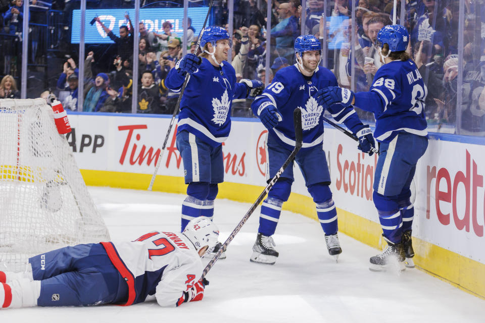 Toronto Maple Leafs right wing William Nylander (88) celebrates after his goal with teammates Rasmus Sandin (38) and Calle Jarnkrok (19) as Washington Capitals defenseman Martin Fehervary (42) looks on during second-period NHL hockey game in Toronto, Ontario, Sunday, Jan. 29, 2023. (Cole Burston/The Canadian Press via AP)