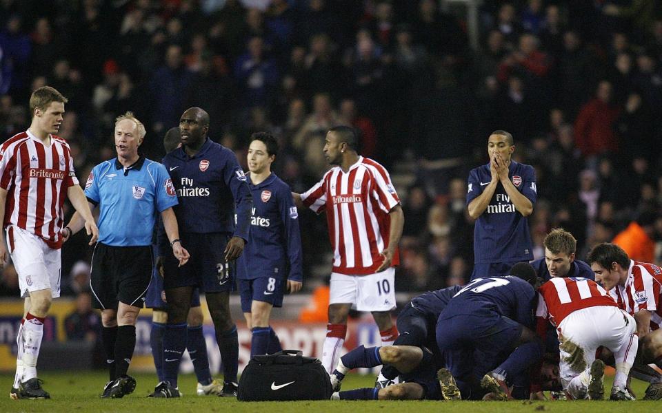 Stoke City's Ryan Shawcross (L) is sent off by referee Peter Walton after a tackle on Arsenal's Aaron Ramsey (floor)