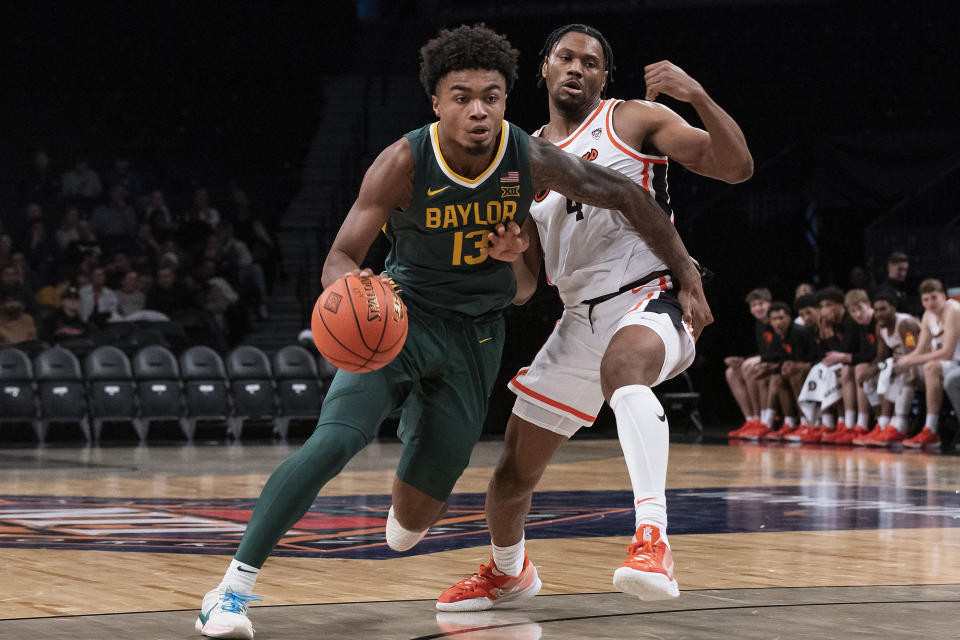 Baylor guard Langston Love (13) drives to the basket against Oregon State guard Dexter Akanno (4) during the second half of an NCAA college basketball game Wednesday, Nov. 22, 2023, in New York. (AP Photo/Eduardo Munoz Alvarez)