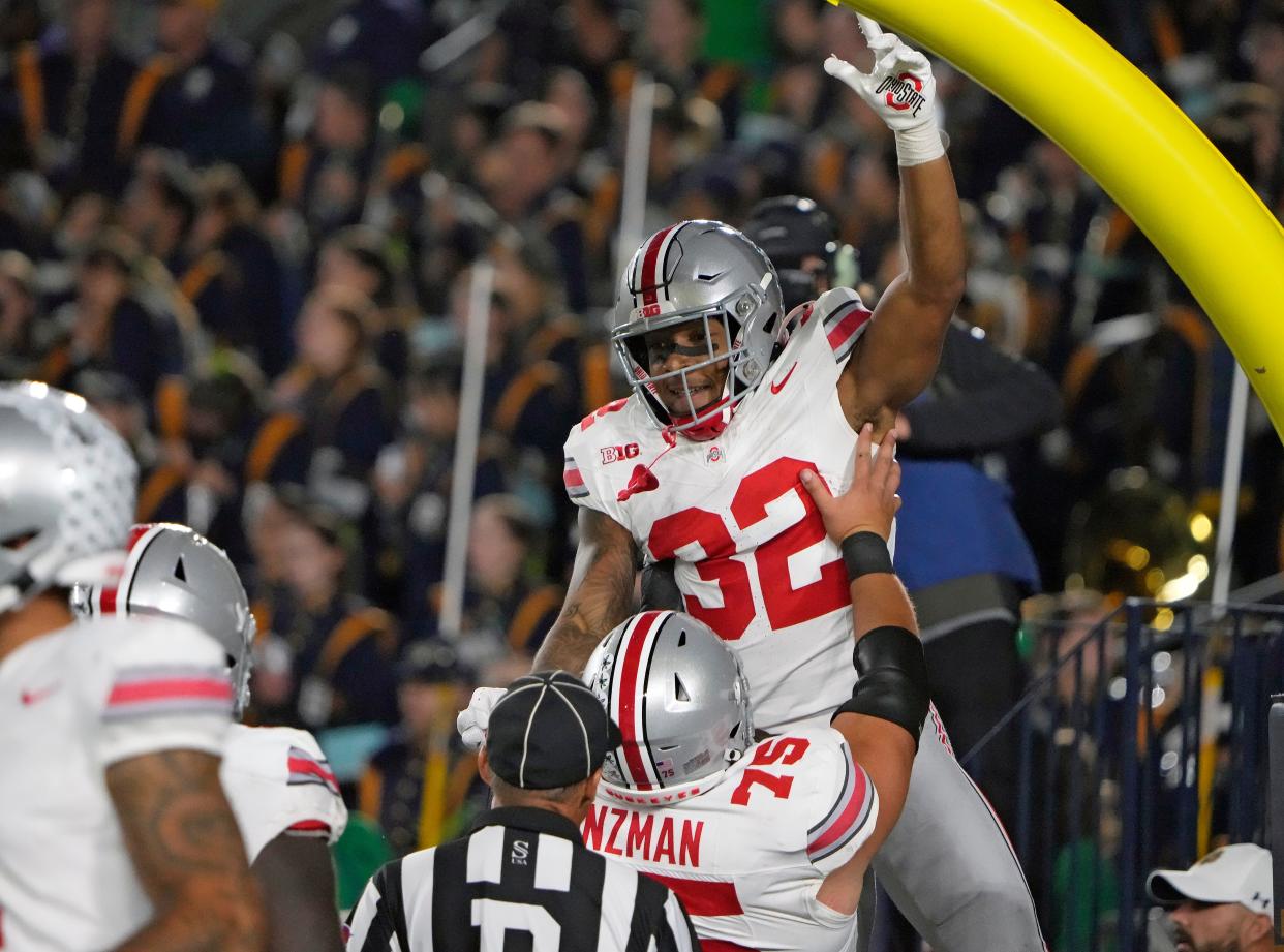 Sep 23, 2023; South Bend, Indiana, USA; Ohio State Buckeyes running back TreVeyon Henderson (32) celebrates his rushing touchdown with Ohio State Buckeyes offensive lineman Carson Hinzman (75) during the third quarter of their game against Notre Dame Fighting Irish at Notre Dame Stadium.