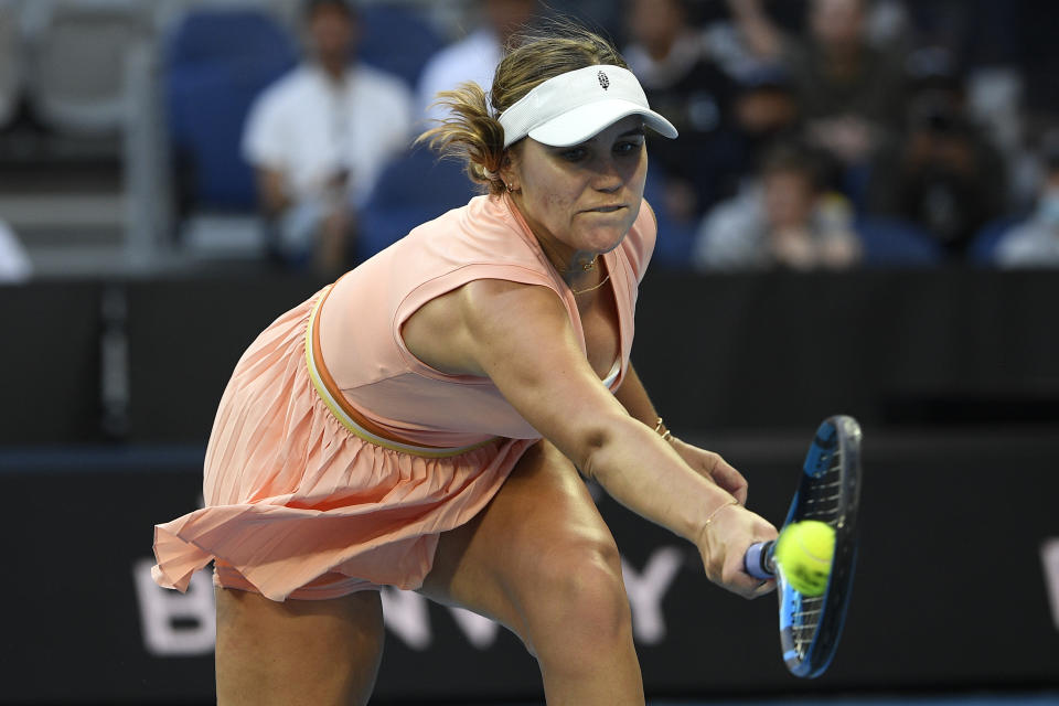 Sofia Kenin of the U.S. plays a backhand return to compatriot Madison Keys during their first round match at the Australian Open tennis championships in Melbourne, Australia, Monday, Jan. 17, 2022. (AP Photo/Andy Brownbill)