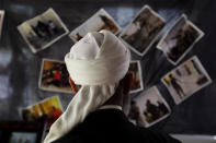 A Houthi supporter looks at pictures during a picture exhibition of late Houthi fighters allegedly killed in Yemen’s ongoing conflict, in Sana'a, Yemen, May 5, 2016. According to reports, Yemen?s warring factions involving in UN-led peace talks in Kuwait have reached an agreement to form joint committees, focusing on disarmament and the withdrawal of militia forces and the rehabilitation of state institutions and political dialogue, in an attempt to bring a permanent end to the ongoing conflict in the troubled Arab state. (YAHYA ARHAB/EPA)