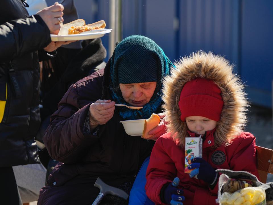 Ekaterina Mosha from Mykolaiv with her grandson Dmitrii in Moldova (Sergei Grits/AP)