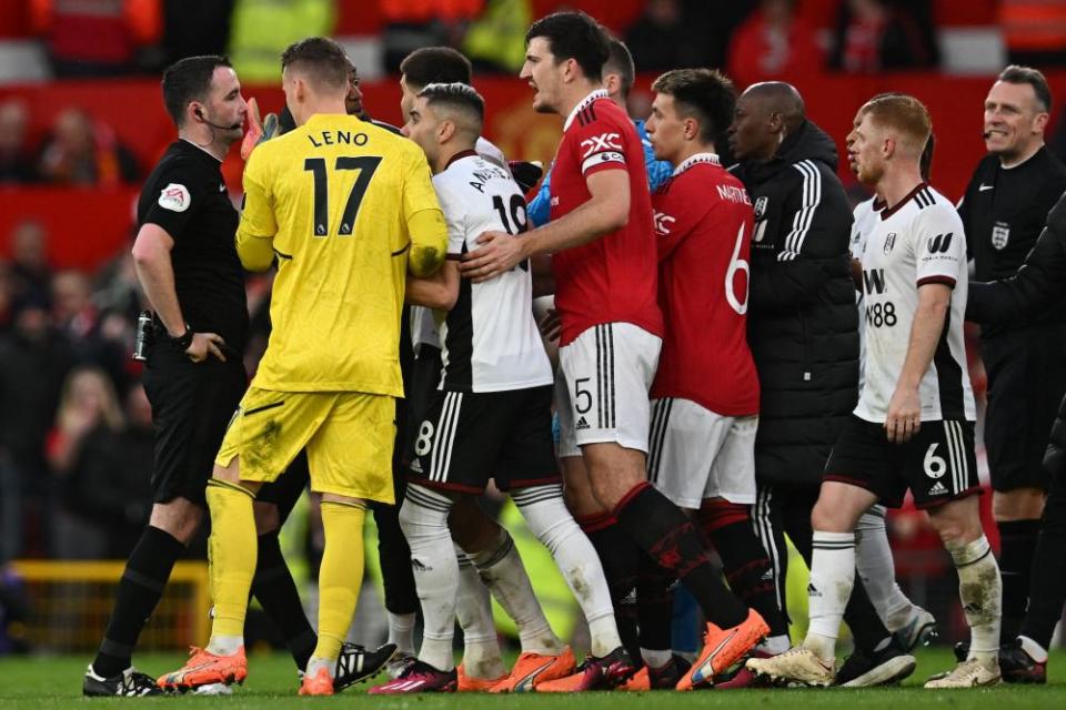 Players surround the referee during Manchester United’s 3-1 victory over Fulham in which three players were sent off.