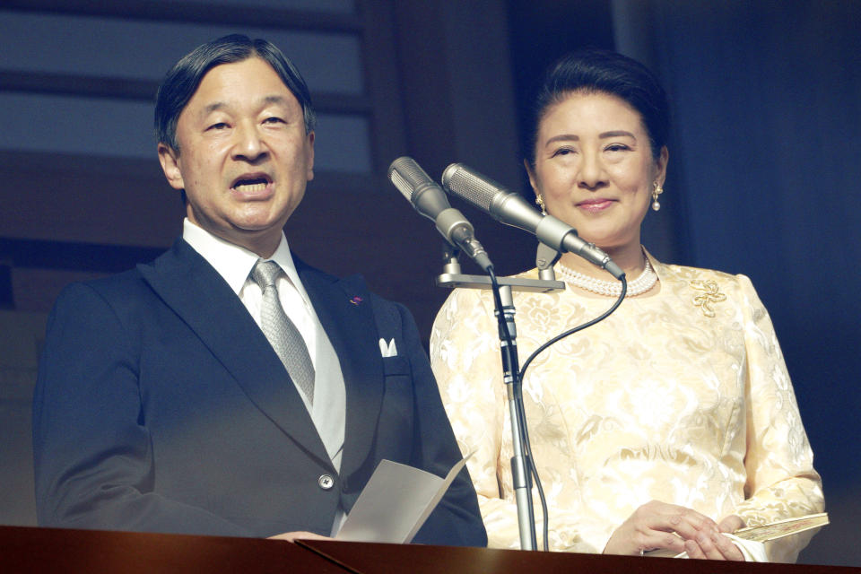 Japan's Emperor Naruhito, accompanied by Empress Masako, speaks to well-wishers from the bullet-proofed balcony during a public appearance with his imperial families at Imperial Palace in Tokyo Thursday, Jan. 2, 2020, in Tokyo. (AP Photo/Eugene Hoshiko)