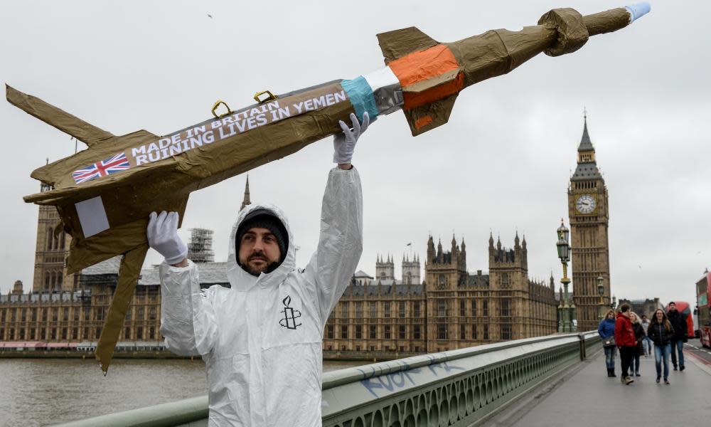 An Amnesty International activist with a homemade replica missile on Westminster Bridge in March 2016.