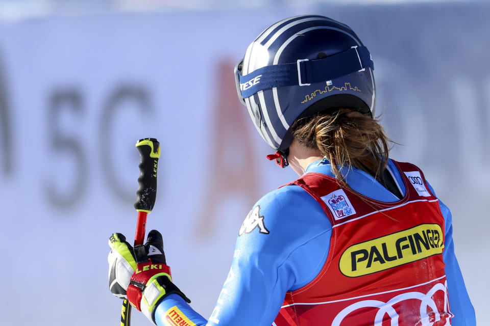 Italy's Sofia Goggia sports Bergamo's skyline on the back of her racing helmet, in the finish area of an alpine ski, women's World Cup downhill race, in Zauchensee, Austria, Saturday, Jan. 15, 2022. Defending Olympic gold medalists Sofia Goggia and Michela Moioli both come from the Bergamo area that was the first epicenter of COVID-19 in Europe. Goggia skis with a design of Bergamo's skyline on the back of her racing helmet. Moioli lost her grandmother to the virus. (AP Photo/Marco Trovati)