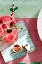 <p>Want to keep things light? This bubbly, festive gin drink has a nice cranberry twist. Serve it with the <a href="https://www.countryliving.com/food-drinks/a29640166/white-chocolate-truffles-recipe/" rel="nofollow noopener" target="_blank" data-ylk="slk:white chocolate truffle;elm:context_link;itc:0;sec:content-canvas" class="link ">white chocolate truffle</a>, pictured at the bottom. </p><p><strong><a href="https://www.countryliving.com/food-drinks/a29639548/cranberry-gin-fizz-recipe/" rel="nofollow noopener" target="_blank" data-ylk="slk:Get the recipe for Cranberry Gin Fizz;elm:context_link;itc:0;sec:content-canvas" class="link ">Get the recipe for Cranberry Gin Fizz</a>.</strong> </p>