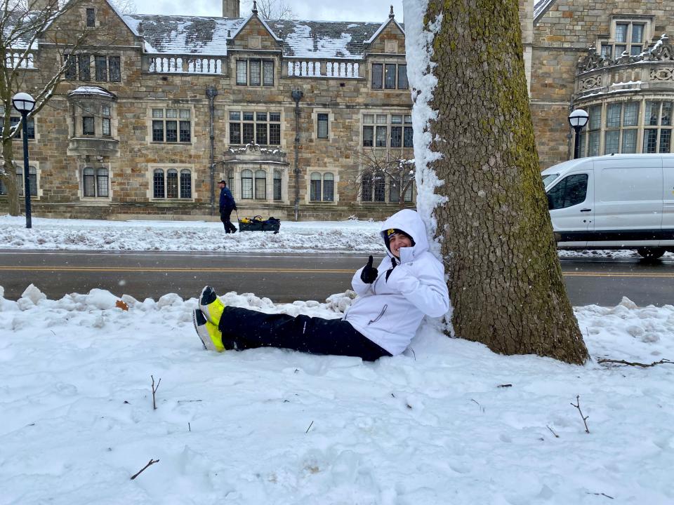 Vincent Jacobson, 22, found a spot under a tree off South University Avenue at 1 p.m. to wait for the University of Michigan football parade to start in Ann Arbor on Saturday, Jan. 13, 2024.