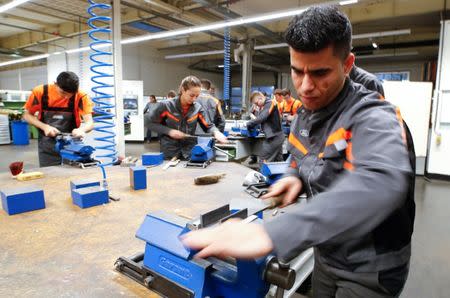 Qudratullah Hotak, a 25-year-old refugee from Afghanistan and one of 24 trainees of Ford Germany's so-called Equipment Qualification (EQ) program to integrate migrants in a booming labour market, uses a rasp at the training workshop of Ford Motor Co in Cologne, Germany, January 11, 2019. Picture taken January 11, 2019. REUTERS/Wolfgang Rattay