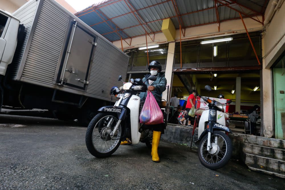 Zaihim Enterprise staff head out to make a delivery from the Taman Tun Sardon Wet Market in Penang March 26, 2020. — Sayuti Zainudin
