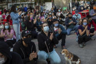 Residents of restricted mobility areas in Madrid due to the coronavirus outbreak gather during a protest to demand more resources for public health system and against social inequality in the southern neighbourhood of Vallecas, Madrid, Spain, Thursday, Sept. 24, 2020. The regional government is set to announce Friday new restrictions in Madrid, where gatherings are limited to a maximum of 6 people and more than 850,000 residents have been partially locked down this week. (AP Photo/Bernat Armangue)