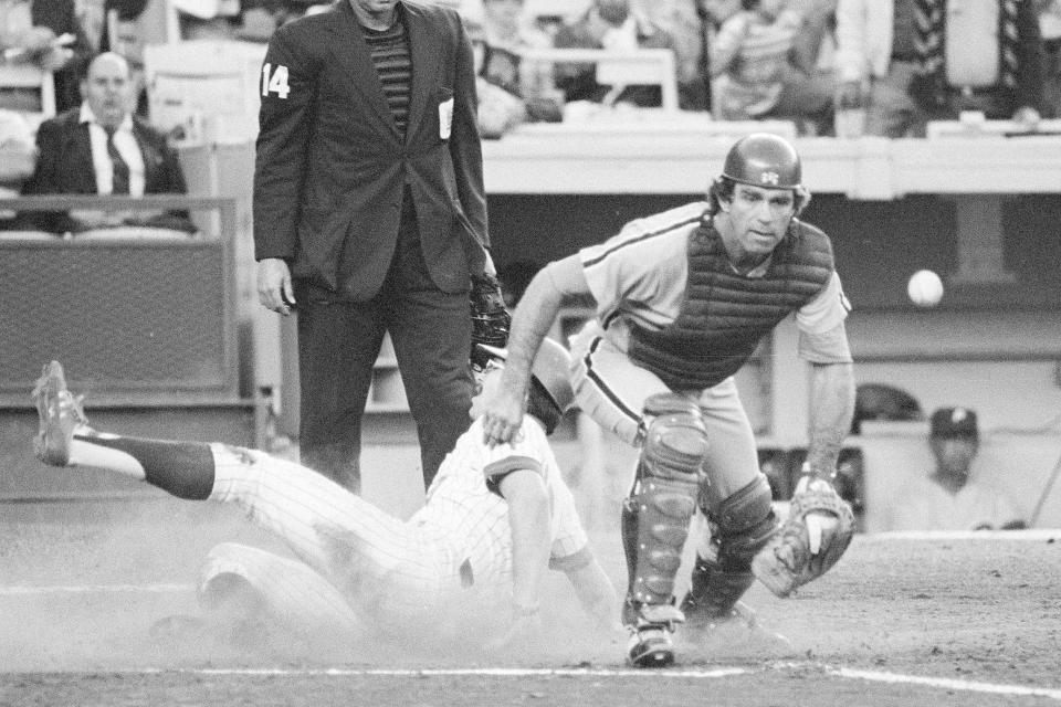 FILE - New York Mets' Tim Foli of the slides across home plate to score in the first inning of a baseball game as the ball gets away from Philadelphia Phillies' catcher Tim McCarver on July 5, 1978, the Shea Stadium in New York. McCarver, the All-Star catcher and Hall of Fame broadcaster who during 60 years in baseball won two World Series titles with the St. Louis Cardinals and had a long run as the one of the country's most recognized, incisive and talkative television commentators, died Thursday morning, Feb. 16, 2023, in Memphis, Tenn., due to heart failure, baseball Hall of Fame announced. He was 81. (AP Photo/Ray Stubblebine, File)