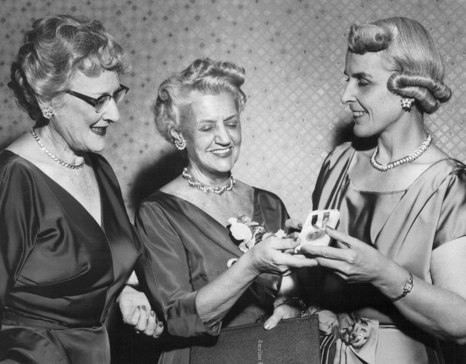 Caroline Gannett, widow of Gannett founder Frank Gannett, served on the state Board of Regents for many years. Here she receives Alfred E. Smith Award from Helen Maney and May M. Henry.