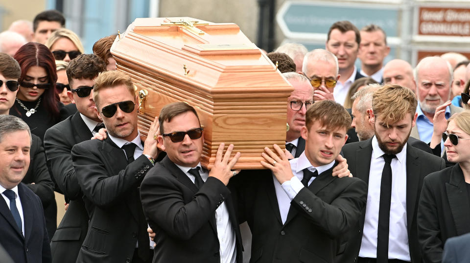 Ronan Keating (centre middle left) helps carry the coffin of his brother Ciaran Keating towards St Patrick's Church in Louisburgh, Co Mayo, for his funeral. The older brother of Ronan Keating died in a two-car crash near Swinford in Co Mayo on Saturday. Picture date: Thursday July 20, 2023. (Photo by Oliver McVeigh/PA Images via Getty Images)