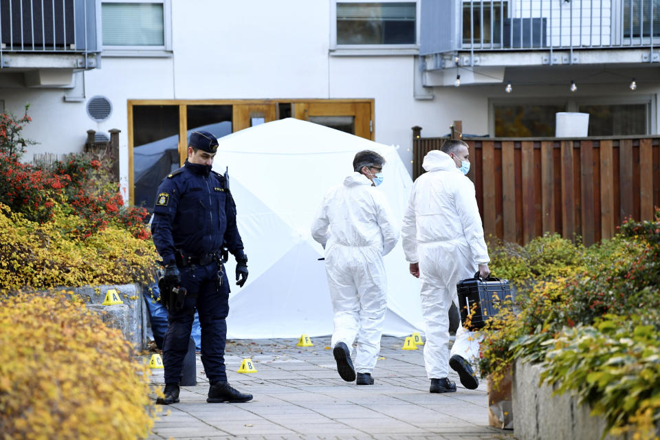 Forensic police work on the site where Swedish rapper Einar was shot to death, in Hammarby Sjostad district in Stockholm, Friday, Oct. 22, 2021. An award-winning 19-year-old Swedish rapper was shot to death in southern Stockholm in an incident that media reports on Friday suggested could be gang-related. The rapper Einar was struck by several bullets in the Hammarby suburb south of central Stockholm and died on the spot late Thursday, police spokesman Ola Osterling told the Swedish news agency TT. (Henrik Montgomery/TT via AP)