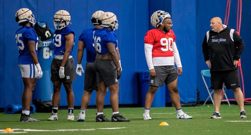 Duke defensive tackle DeWayne Carter (90) talks with defensive line coach Jess Simpson during the Blue Devils’ spring practice on Friday, March 24, 2023 in Durham, N.C.